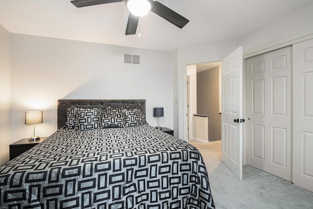 bedroom featuring carpet floors, a closet, visible vents, and a ceiling fan