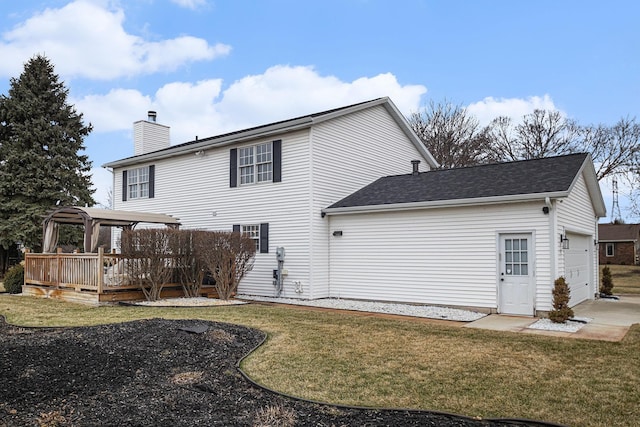 rear view of property featuring a deck, a garage, a lawn, a pergola, and a chimney