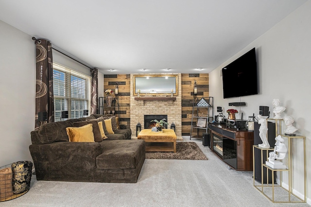 living area featuring a brick fireplace, light carpet, and wooden walls