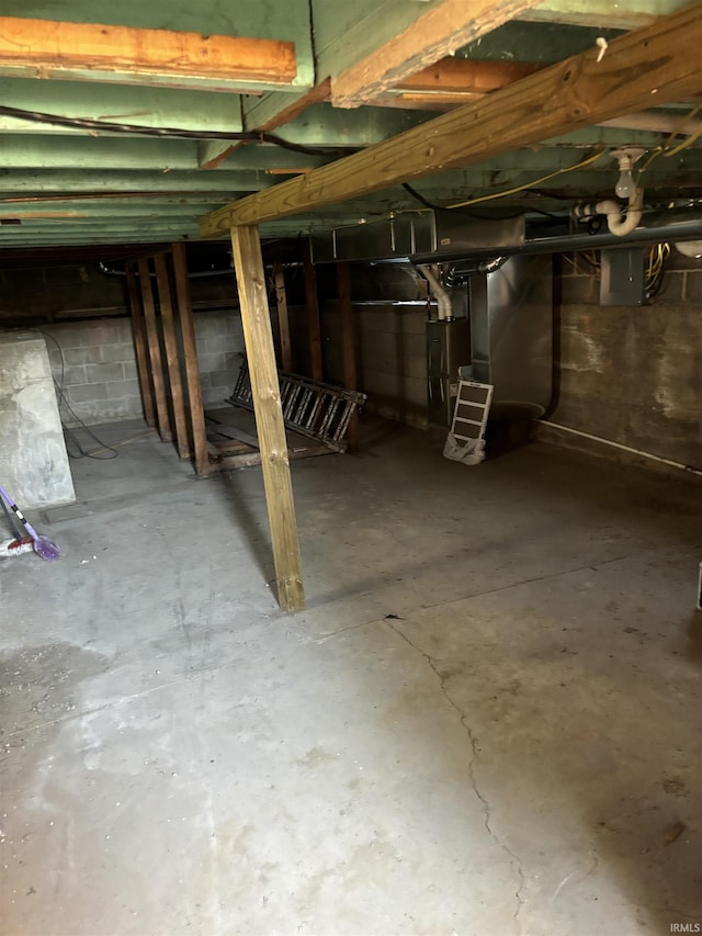 basement with water heater and electric panel