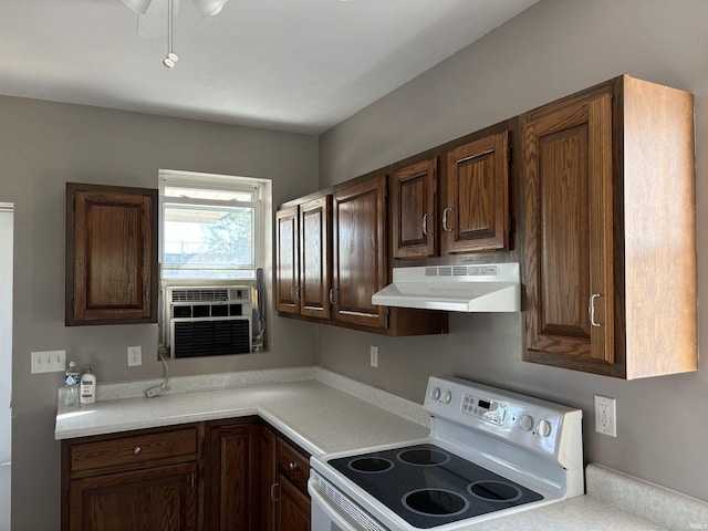 kitchen featuring cooling unit, dark brown cabinetry, under cabinet range hood, light countertops, and white electric range oven