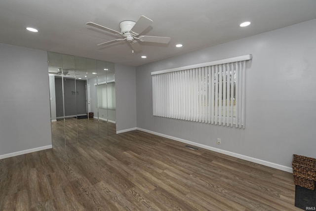 unfurnished room with recessed lighting, visible vents, a ceiling fan, wood finished floors, and baseboards