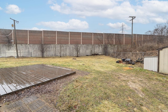 view of yard with a fenced backyard and a wooden deck