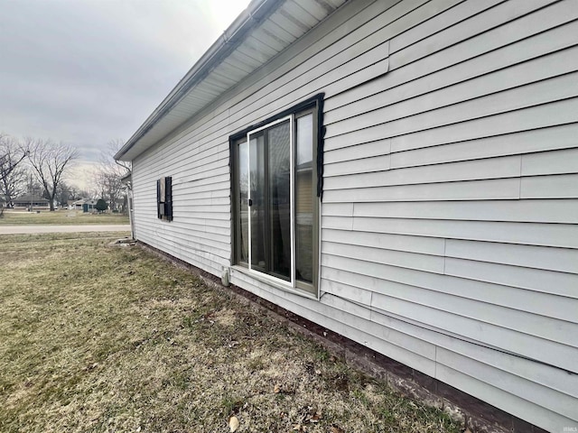 view of property exterior with a lawn