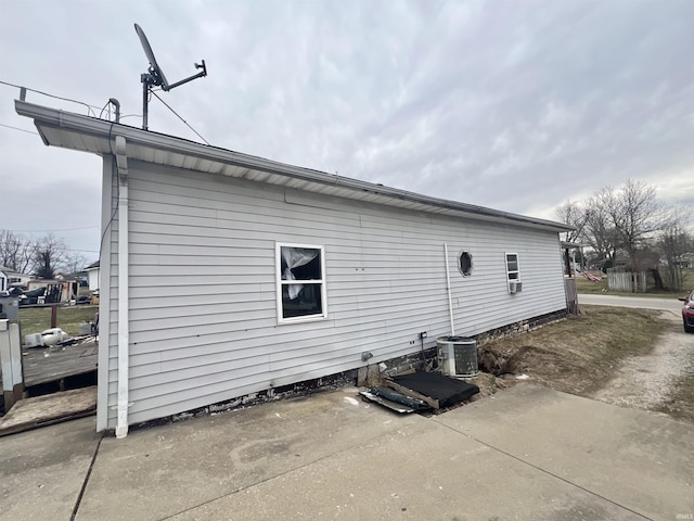 view of side of home featuring central AC