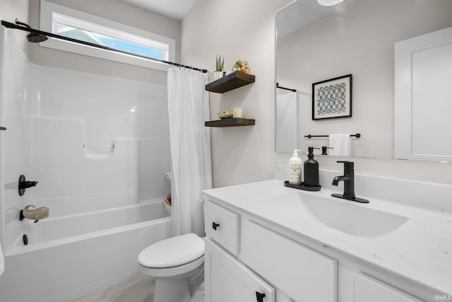 bathroom with shower / tub combo, vanity, and toilet