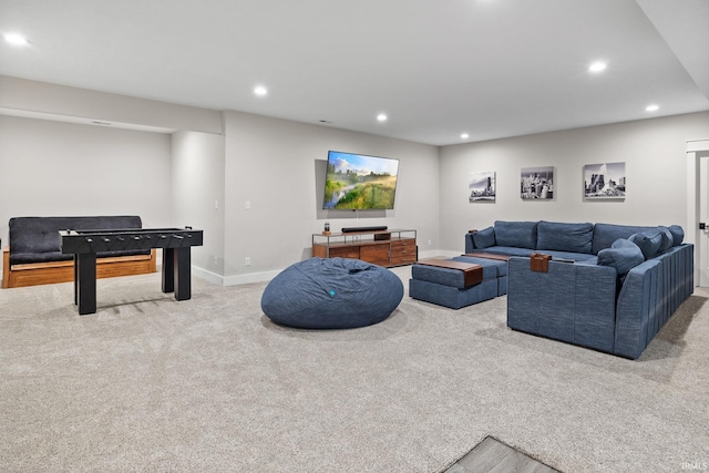 carpeted living area featuring recessed lighting and baseboards