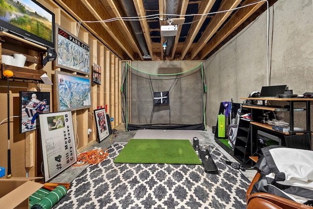 recreation room featuring unfinished concrete floors