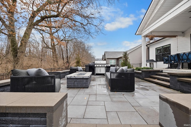 view of patio / terrace featuring an outdoor living space with a fire pit