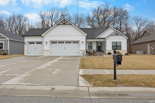 view of front of house featuring a garage, a shingled roof, concrete driveway, a front lawn, and brick siding