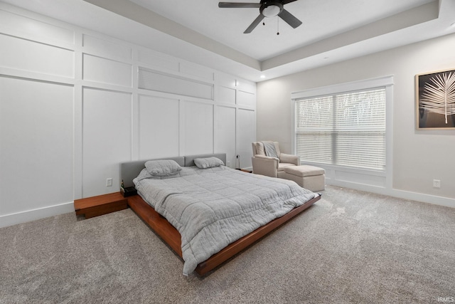 bedroom featuring baseboards, carpet floors, ceiling fan, and a decorative wall