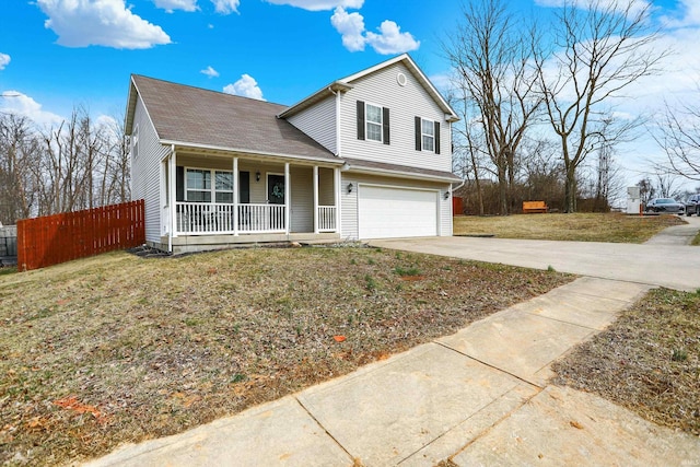 traditional home featuring a porch, an attached garage, a front yard, fence, and driveway