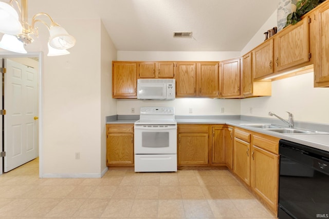 kitchen with white appliances, a sink, visible vents, vaulted ceiling, and light countertops