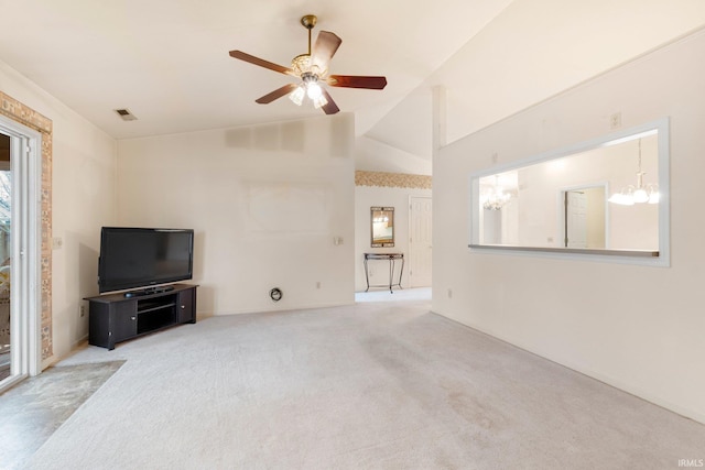 unfurnished living room with lofted ceiling, carpet floors, ceiling fan with notable chandelier, and visible vents