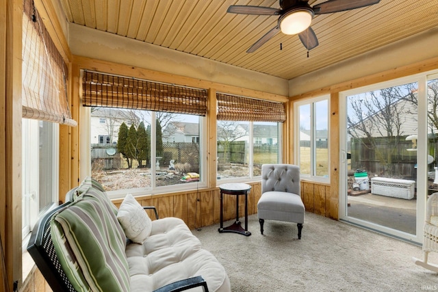 sunroom with ceiling fan and wooden ceiling