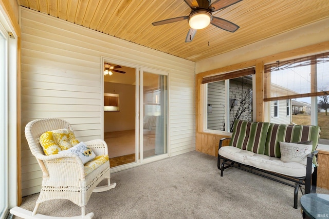 sunroom / solarium featuring wood ceiling and ceiling fan