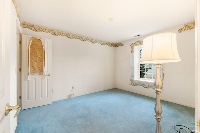 spare room with light colored carpet, visible vents, and baseboards