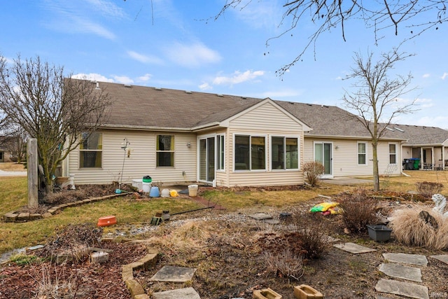 back of property with a shingled roof