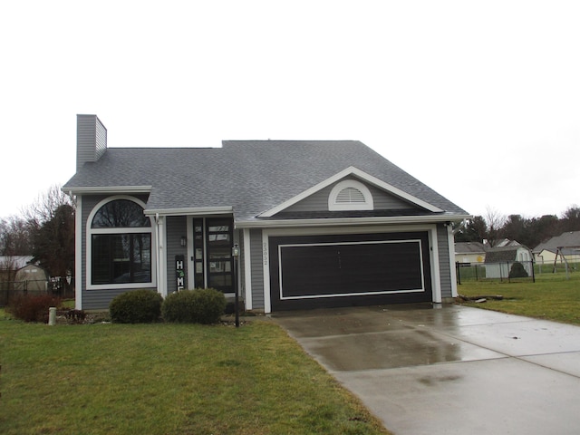 ranch-style home with driveway, a garage, fence, and a front yard