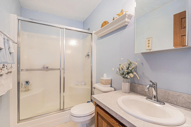 full bathroom with a textured ceiling, vanity, a shower stall, and toilet