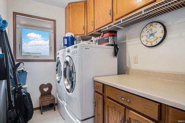 laundry area with cabinet space and separate washer and dryer