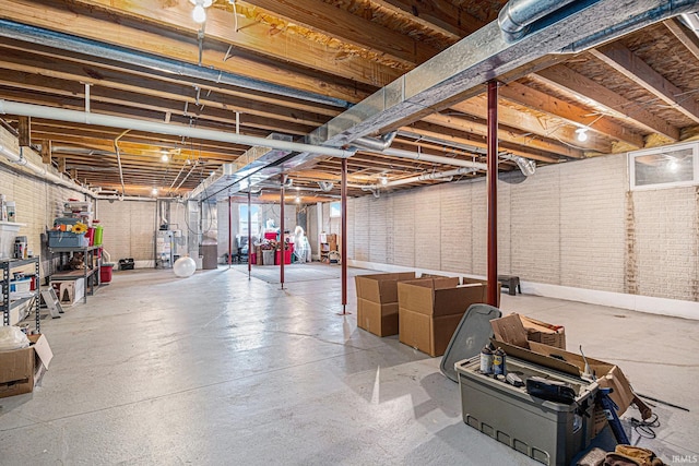 below grade area featuring brick wall and gas water heater