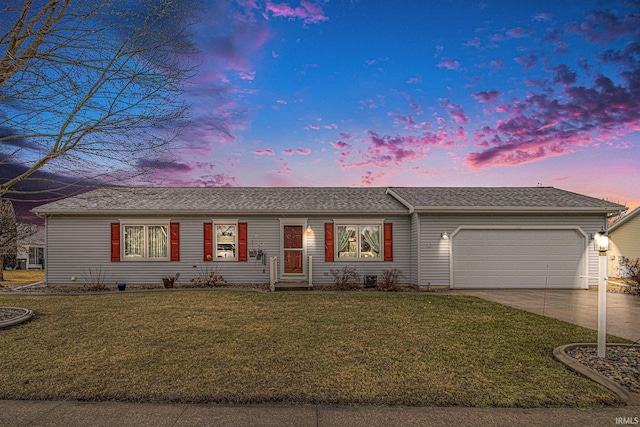 single story home with a garage, a lawn, and concrete driveway