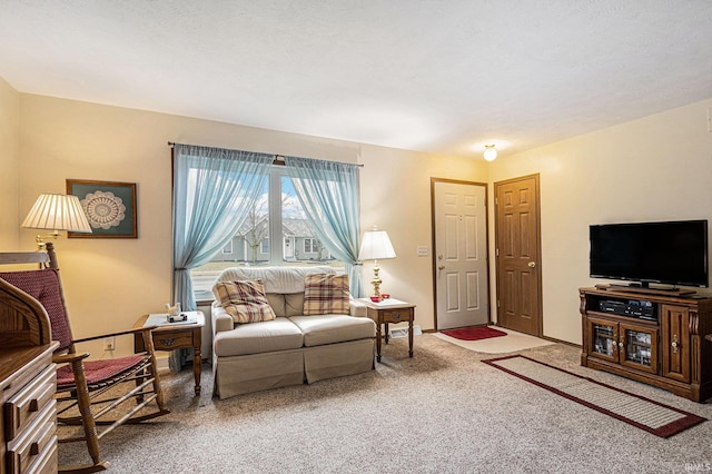 living room with carpet and baseboards