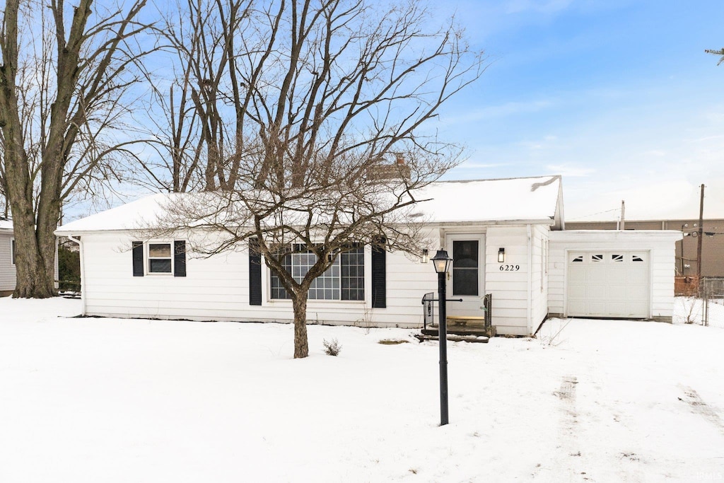 single story home featuring an attached garage