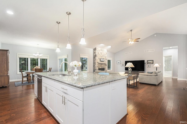 kitchen featuring dark wood-style floors, visible vents, light stone counters, and a sink