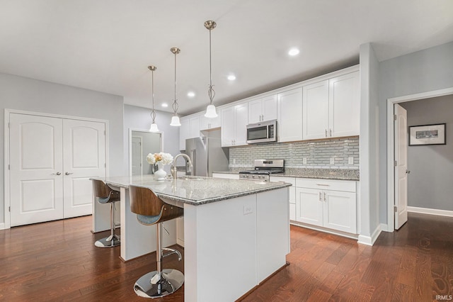 kitchen featuring appliances with stainless steel finishes, white cabinetry, and dark wood finished floors