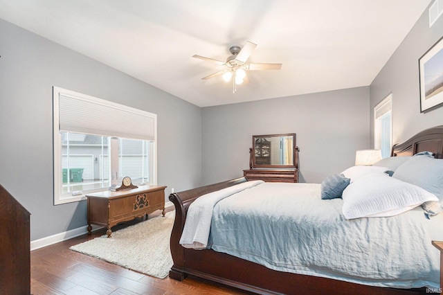 bedroom with ceiling fan, baseboards, and wood finished floors