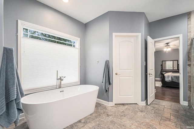 bathroom featuring a soaking tub, connected bathroom, and baseboards