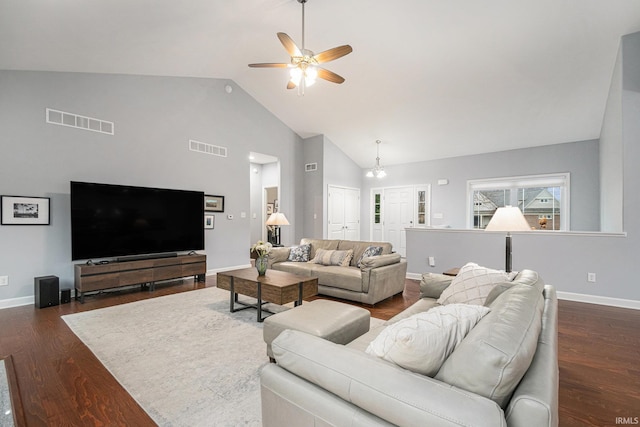 living area featuring baseboards, visible vents, and dark wood finished floors