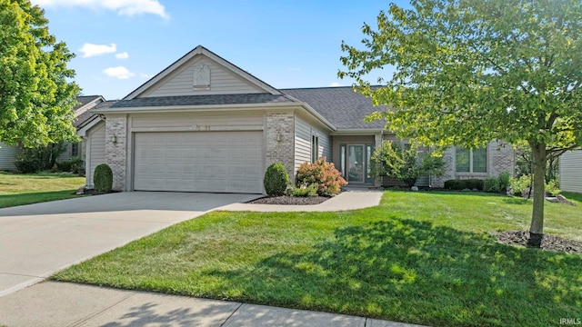 view of front of home with brick siding, a shingled roof, an attached garage, a front yard, and driveway