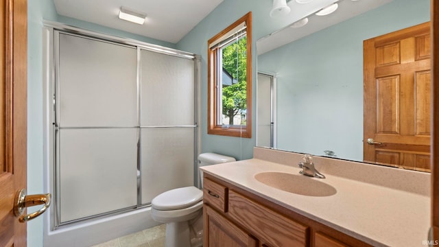 full bathroom with a stall shower, vanity, and toilet