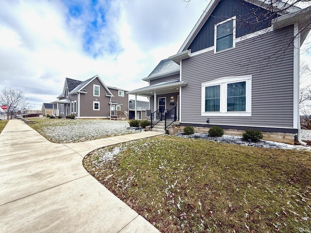 view of side of home with board and batten siding and a lawn