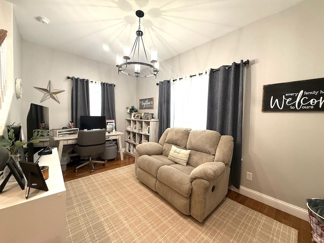 office with a notable chandelier, baseboards, and wood finished floors