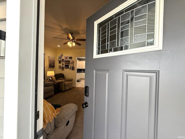 interior space featuring ceiling fan and carpet