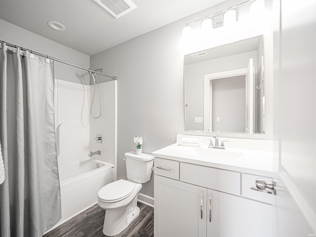 bathroom with toilet, shower / tub combo, wood finished floors, visible vents, and vanity