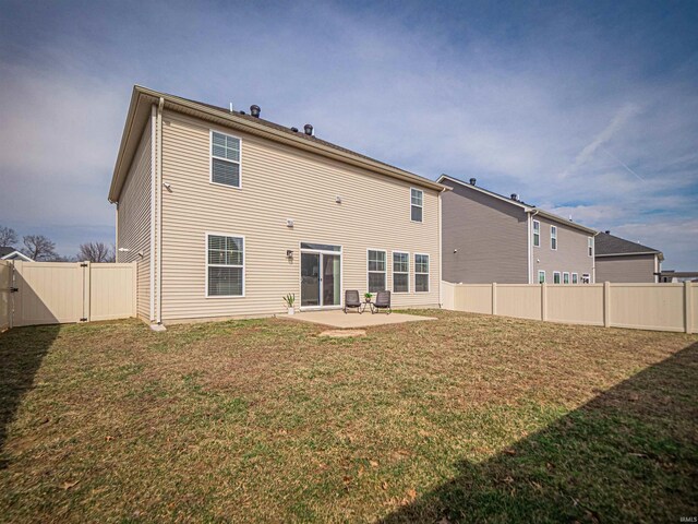 back of property with a yard, a fenced backyard, a gate, and a patio