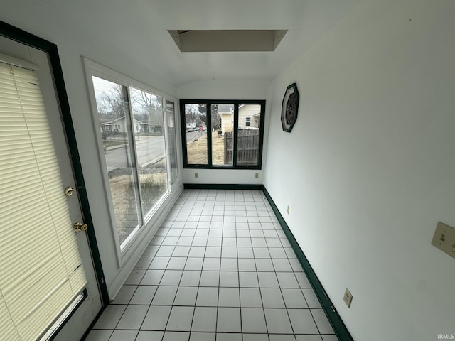 unfurnished sunroom featuring vaulted ceiling