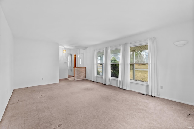 unfurnished living room with carpet floors and visible vents