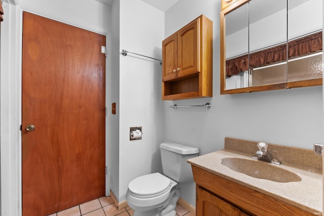 bathroom with toilet, tile patterned flooring, baseboards, and vanity