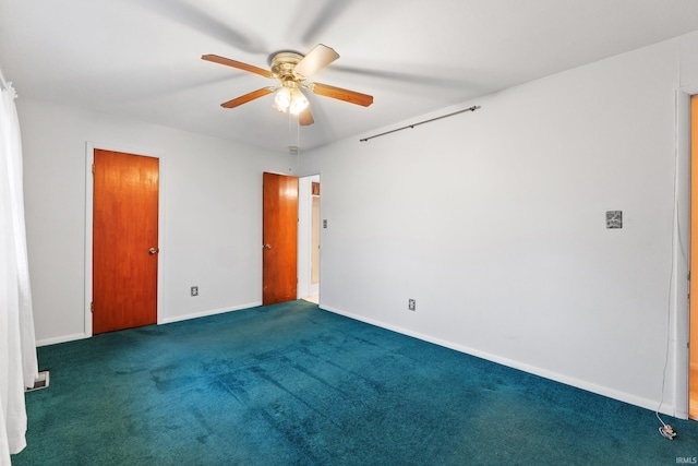 spare room with carpet floors, baseboards, and a ceiling fan