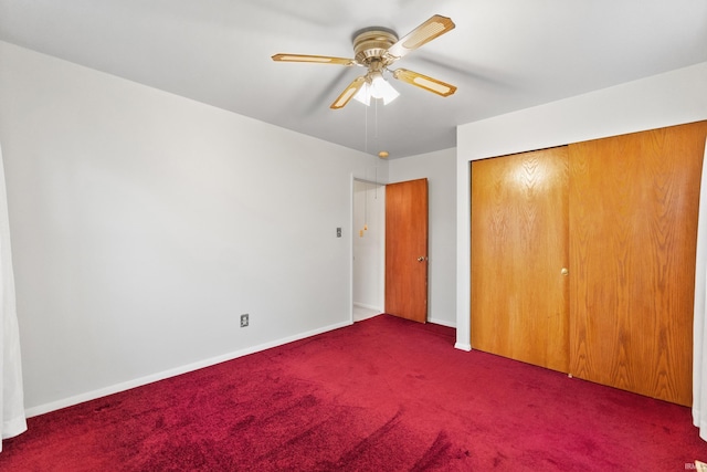 unfurnished bedroom featuring a closet, carpet flooring, a ceiling fan, and baseboards