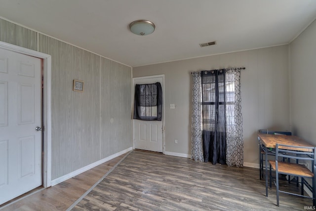 interior space with visible vents, baseboards, and wood finished floors