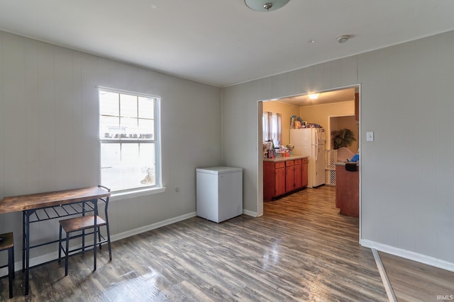 office space with baseboards and wood finished floors