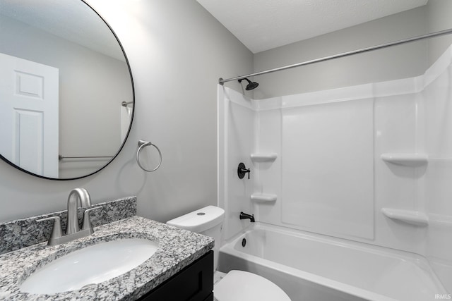 bathroom featuring a textured ceiling, shower / tub combination, vanity, and toilet