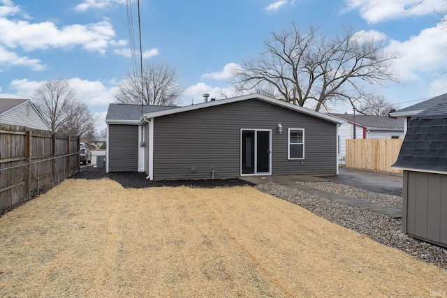 rear view of property with fence